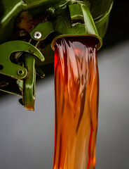 Pouring red diesel from a dark green jerrycan 