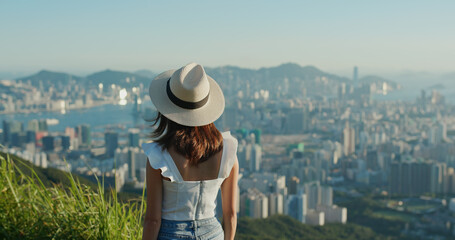 Fototapeta premium Woman enjoy the city view on mountain