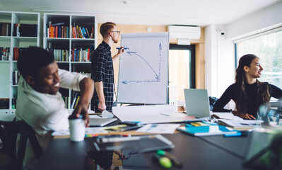 Multiracial colleagues during presentation in modern workspace