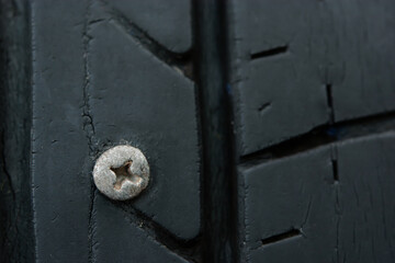 Close up metal screws nails embroidered in tires