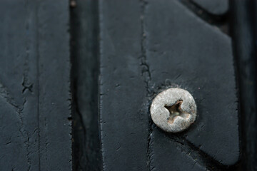Close up metal screws nails embroidered in tires