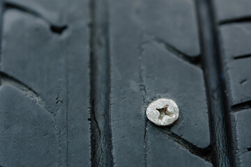 Close up metal screws nails embroidered in tires