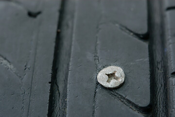 Close up metal screws nails embroidered in tires