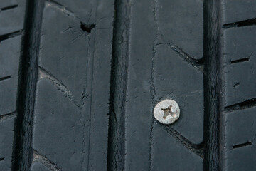 Close up metal screws nails embroidered in tires