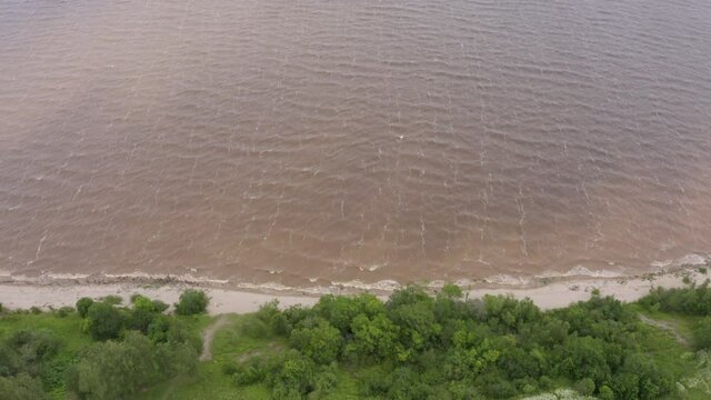 Panoramic aerial view of Lake Ilmen near Veliky Novgorod, natural attractions of Russia. Strong wind and waves on a sunny summer day.