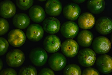 Top view of green oranges on the water. Close up of freshly harvested oranges background.