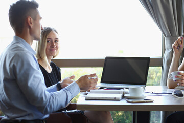 Business meeting in a cafe young businessmen