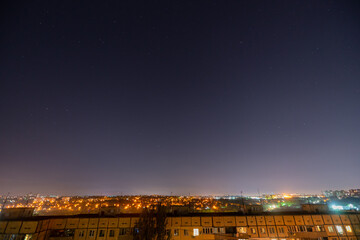 Fototapeta premium Night starry cityscape with a lot of stars and constellations.
