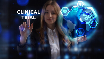 Business, Technology, Internet and network concept. Young businessman working on a virtual screen of the future and sees the inscription: Clinical trial