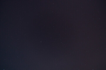 Night starry sky with a lot of stars and constellations in the city.