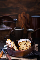 Delicious homemade cottage cheese and raisins loaf cake on dark rustic wooden background