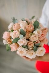 Woman holding in hands big wedding bouquet in rustic style. 