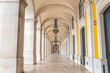 Arcade with beautiful lamps and architectural details in Praca do Comercio, Lisbon - Portugal