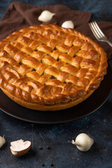 Mushroom pie on blue background. Tasty pie. Cooking together. Homemade food. Fragrant pie.