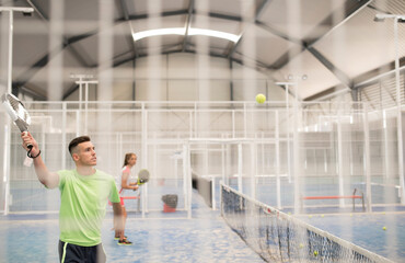 paddle tennis indoors training, man hits ball