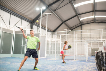 Fototapeta na wymiar paddle tennis indoors training, active people playing