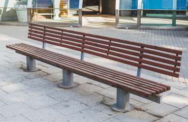 Wooden bench in the city to sit several people.