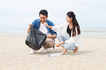  Asian man and woman help to cleaning the beach