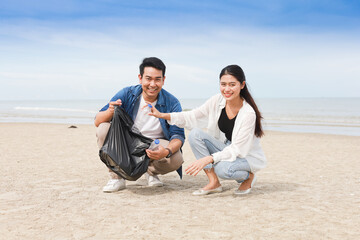  Asian man and woman help to cleaning the beach