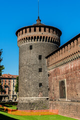 Sforza castle (Castello Sforzesco, XV century) and huge medieval walls in Piazza Castello (Castle square). Milan, Italy.