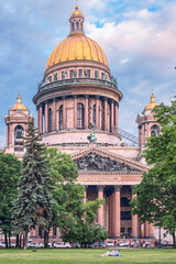 Saint Petersburg, Russia - June 16, 2020 - Magnificent St. Isaac's Cathedral with people resting on the lawn