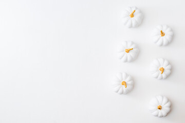Flat lay pattern with pumpkins on a white background