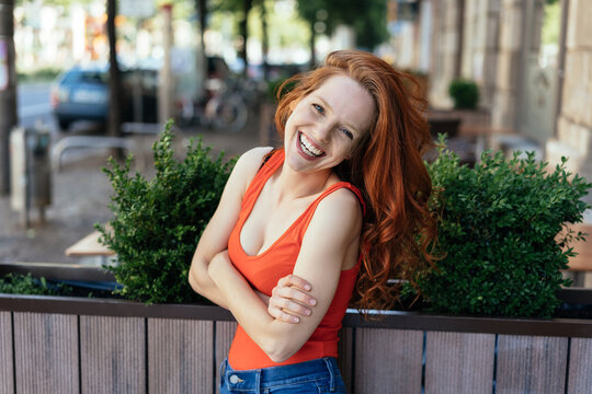 Laughing relaxed casual young redhead woman
