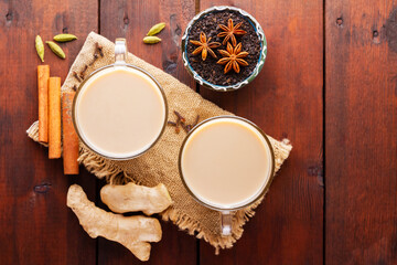 Masala chai tea on burlap. Traditional indian drink - masala tea with spices on a wooden background. Copy space. Top view