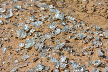 shards of glass close-up on the sand