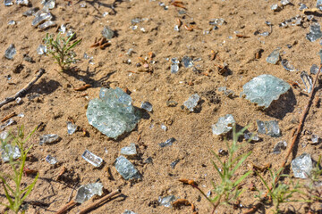 shards of glass close-up on the sand