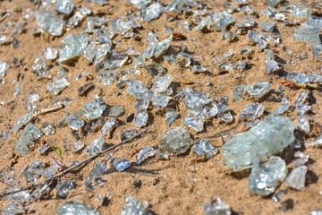 shards of glass close-up on the sand