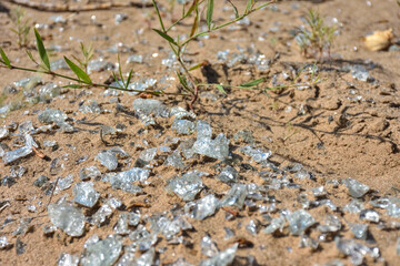 shards of glass close-up on the sand