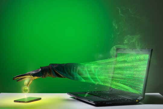 The hacker's hand will hack and steal bitcoins through the monitor screen from your smartphones - Powered by Adobe
