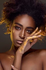 Foto auf Acrylglas Beautiful african woman with natural make-up with gold sparkles on her face and body. Ethnic makeup. Fashion and Style © Detkov D