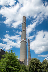 Fototapeta na wymiar brick industrial chimney at the cloudy sky. Industry concept image. Old factory, ecology, industrial renewal, globalization.