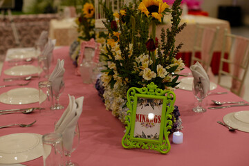 Indoors wedding reception venue with decor, selective focus on flowers