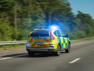 Welsh Ambiwlans Ambulance Paramedic Rapid Response Car Speeding Along Road On Blue Lights 