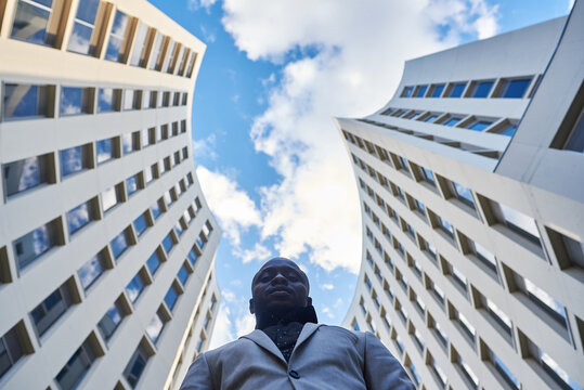 African American businessman between buildings.