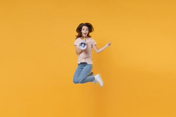 Full length portrait of excited young woman 20s in pastel pink casual t-shirt posing jumping...