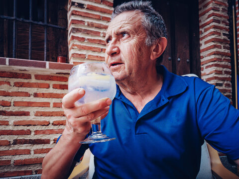Retiree tasting a combination of premium gin with tonic water