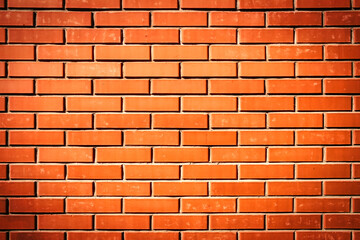 Red brick wall. Background of a new brick house with strong vignette effect.