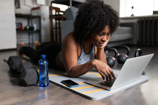 Positive African American athlete browsing laptop
