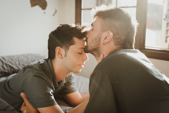 Gay couple kissing lying on the bed. LGBT