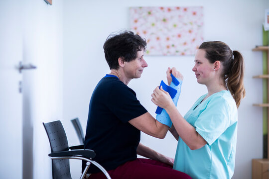 nurse tigthing a armbracer to a patient female