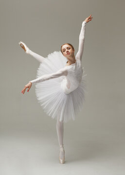 Young Woman In White Ballet Dress Dancing Indoors