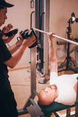 Professional shooting of bold man in gym