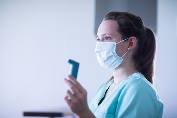 nurse with mouthpiece and syringe