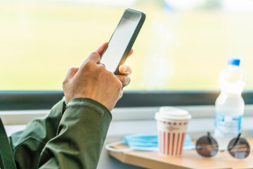 Man eat breakfast inside train bus subway public transport window view and blue seats people tourist new normal social distancing safe travel with hygiene face mask protect from covid corona virus