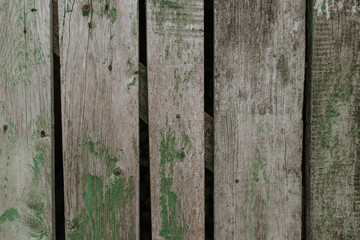 old shabby gray fence made of wooden boards. background texture wall