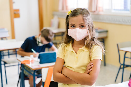 Children In Their School Classroom Wearing Masks During The Covid Pandemic